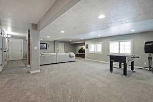 Recreation room featuring recessed lighting, carpet, and a textured ceiling