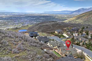 Birds eye view of property with a water and mountain view and a residential view