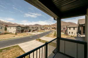 Balcony featuring a residential view and a mountain view