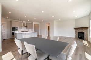 Dining room with recessed lighting, light wood finished floors, and baseboards
