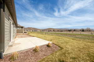 View of yard featuring a mountain view, a patio, and a rural view