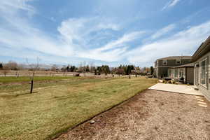 View of yard with a rural view and a patio