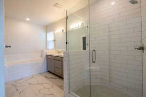 Full bath featuring a bath, vanity, recessed lighting, marble finish floor, and a stall shower