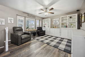 Sitting room featuring washer / clothes dryer, ceiling fan, and wood finished floors
