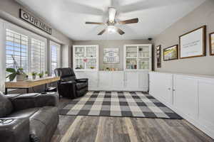 Sitting room featuring ceiling fan and dark wood-style floors