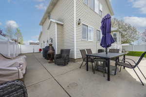 View of patio / terrace featuring outdoor dining space, a fenced backyard, and a gate