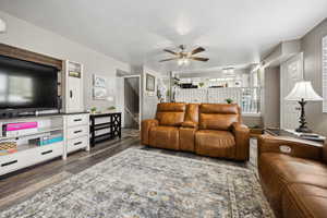 Living room featuring a ceiling fan and wood finished floors