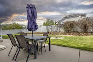 View of patio with a fenced backyard and outdoor dining area