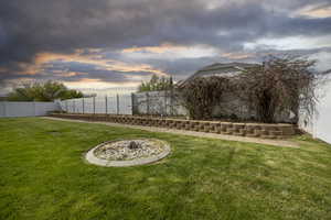 Yard at dusk with a fenced backyard