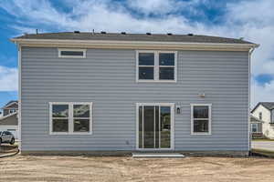 Back of property featuring roof with shingles