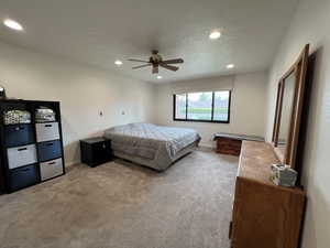 Bedroom with recessed lighting, carpet, a textured ceiling, and baseboards