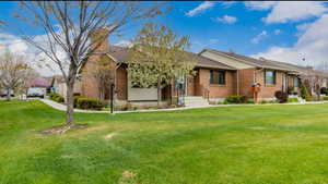 Ranch-style home with brick siding and a front yard