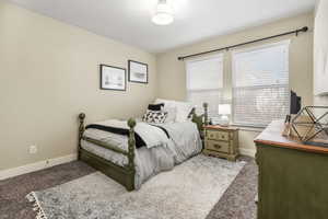 Bedroom with carpet flooring and baseboards