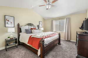 Bedroom with ceiling fan, baseboards, light carpet, and lofted ceiling