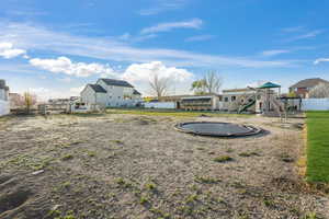 View of yard featuring fence and a playground