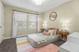 Bedroom with baseboards and carpet floors