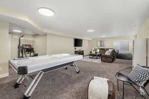 Game room with carpet flooring and baseboards