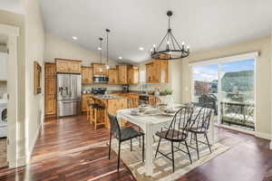 Dining space with washer / clothes dryer, recessed lighting, dark wood-style flooring, a notable chandelier, and baseboards