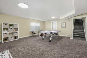 Rec room featuring visible vents, baseboards, and carpet flooring