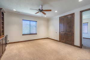 Unfurnished bedroom featuring light carpet, baseboards, ornamental molding, and visible vents