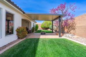 View of yard with a patio area, a fenced backyard, and an outdoor fire pit