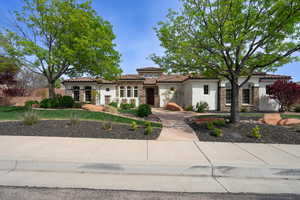 Mediterranean / spanish home featuring stucco siding, stone siding, and a tile roof