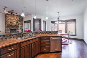 Kitchen featuring dark wood-type flooring, a textured ceiling, a sink, and a ceiling fan