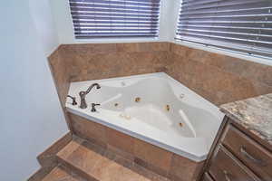 Bathroom featuring a tub with jets