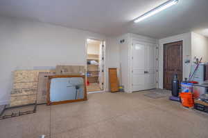 Interior space featuring visible vents, baseboards, and carpet