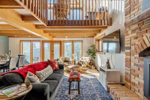 Living area with a towering ceiling and beamed ceiling