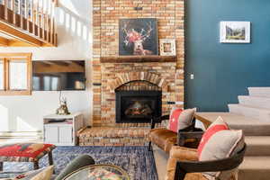 Living area with stairway and a fireplace