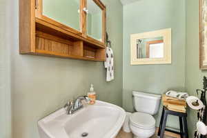 Half bathroom with a sink and toilet