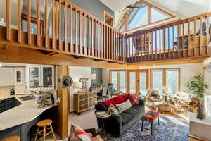 Living room with high vaulted ceiling and french doors