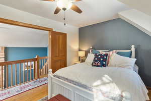 Bedroom with ceiling fan and hardwood / wood-style floors