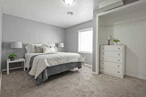 Carpeted bedroom featuring visible vents, baseboards, and a textured ceiling