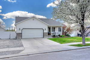 Ranch-style home with a gate, an attached garage, a front lawn, fence, and covered porch