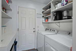 Clothes washing area featuring laundry area and separate washer and dryer