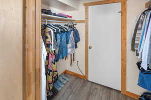 Walk in closet featuring wood finished floors
