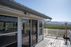 Sliders out of sunroom to wrap deck with views in every direction