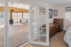 French doors leading out of primary suite to enclosed sunroom