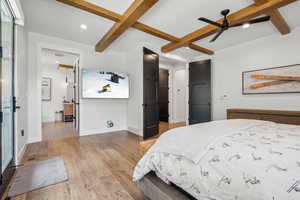 Bedroom featuring baseboards, recessed lighting, visible vents, beam ceiling, and wood finished floors