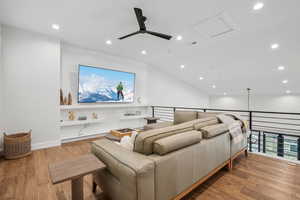 Cinema featuring wood finished floors, a ceiling fan, visible vents, and recessed lighting