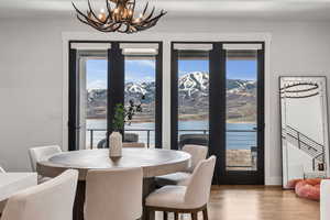 Dining area with wood finished floors and an inviting chandelier