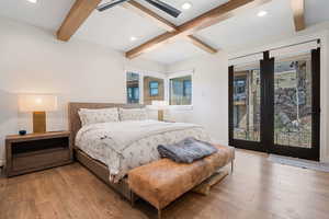 Bedroom with beamed ceiling, access to exterior, recessed lighting, and wood finished floors
