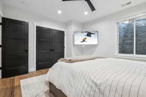 Bedroom with a closet, recessed lighting, visible vents, ceiling fan, and wood finished floors