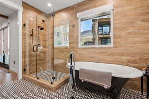 Bathroom featuring a shower stall and a soaking tub