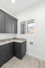 Kitchen with baseboards and light wood-type flooring