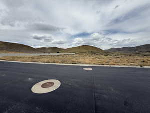 View of road featuring a mountain view and curbs
