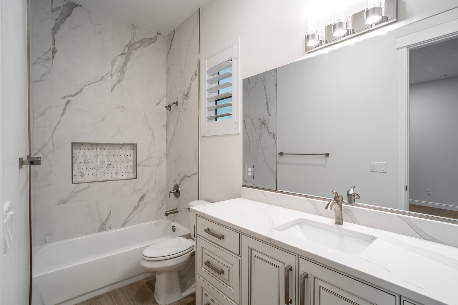 Full bathroom featuring toilet, vanity, wood finished floors, and shower / bathtub combination