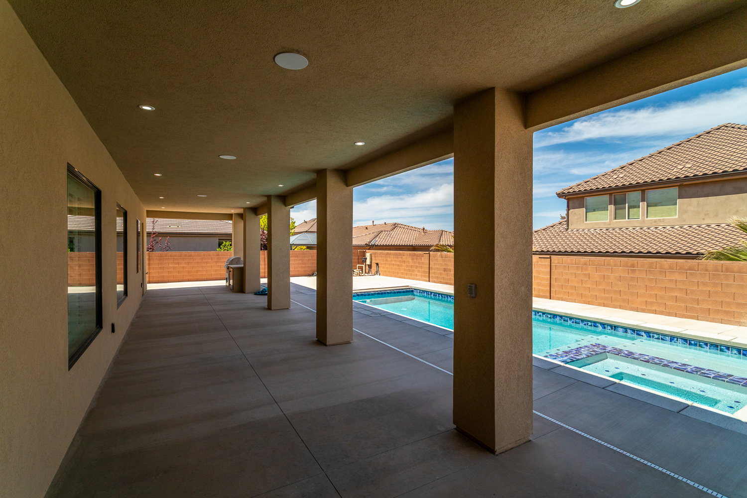 View of swimming pool featuring a patio, a pool with connected hot tub, and a fenced backyard